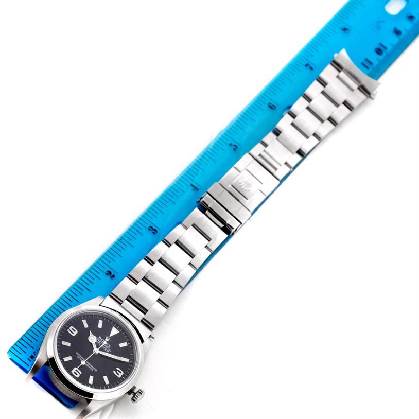 The image shows the Rolex Explorer 14270 Men's Stainless Steel Black Dial 14270 Men's Stainless Steel Black Dial watch laid flat, with a blue ruler beside it for size reference.