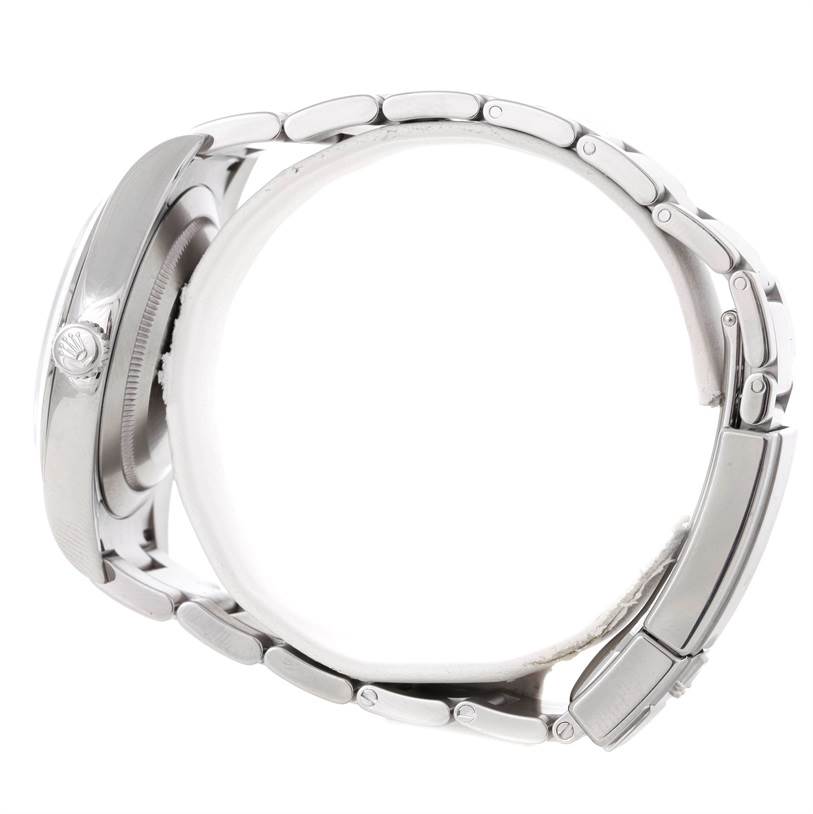 This side view of the Rolex Explorer 214270 Men's Stainless Steel Black Dial 214270 Men's Stainless Steel Black Dial watch shows the crown, case, and bracelet.