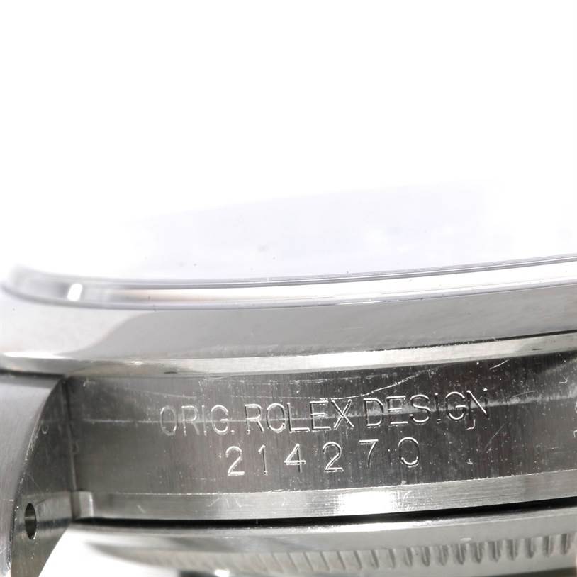 The image shows a close-up side view of the Rolex Explorer 214270 Men's Stainless Steel Black Dial 214270 Men's Stainless Steel Black Dial's case with "ORIG. ROLEX DESIGN" and the model number engraved.