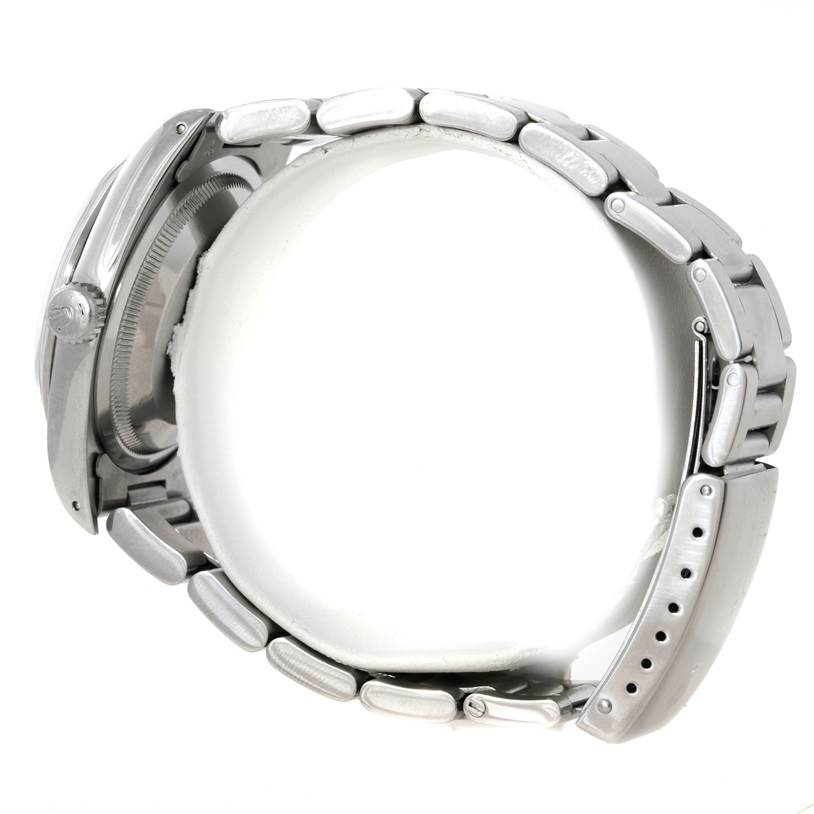 The Rolex Explorer 14270 Men's Stainless Steel Black Dial 14270 Men's Stainless Steel Black Dial watch is shown from the side, highlighting the crown, case, and bracelet links.