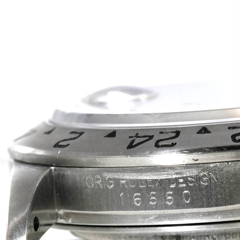 The image shows a close-up side view of the Rolex Explorer 16550 Men's Stainless Steel White Dial 16550 Men's Stainless Steel White Dial model, highlighting the bezel and part of the watch case with its engraved design number.