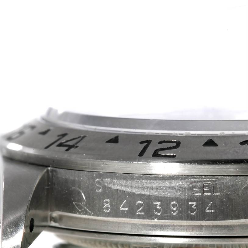 The image shows a close-up of the bezel, serial number, and part of the case of a Rolex Explorer 16550 Men's Stainless Steel White Dial 16550 Men's Stainless Steel White Dial watch.