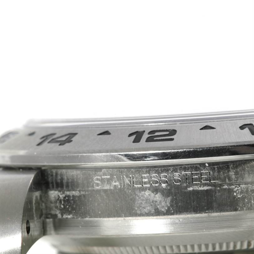 This close-up image shows the stainless steel case and bezel of a Rolex Explorer 216570 Men's Stainless Steel Black Dial 216570 Men's Stainless Steel Black Dial watch.