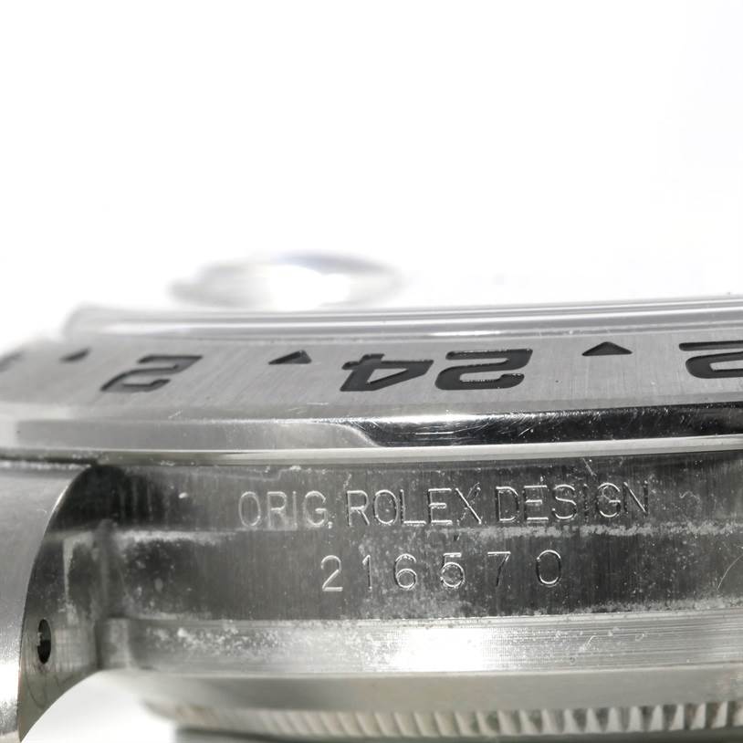 The image shows a close-up of the side of the Rolex Explorer 216570 Men's Stainless Steel Black Dial 216570 Men's Stainless Steel Black Dial watch, highlighting the bezel and engraving.