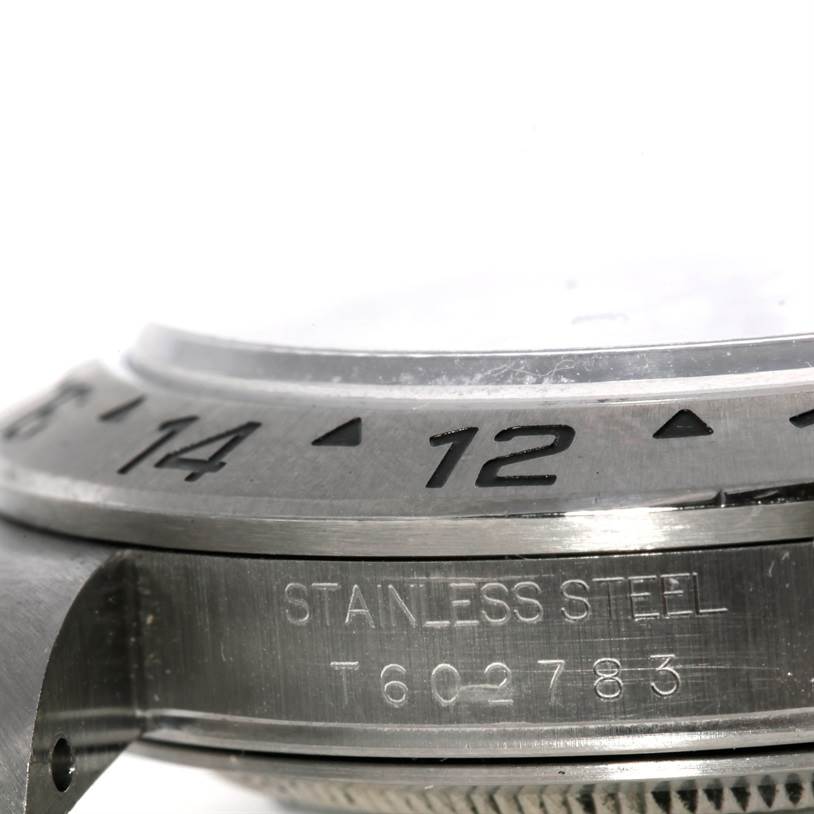 The image shows a close-up angle of the bezel and case side of a Rolex Explorer 16570 Men's Stainless Steel White Dial 16570 Men's Stainless Steel White Dial watch, featuring the stainless steel markings and part of the bezel's numerals.