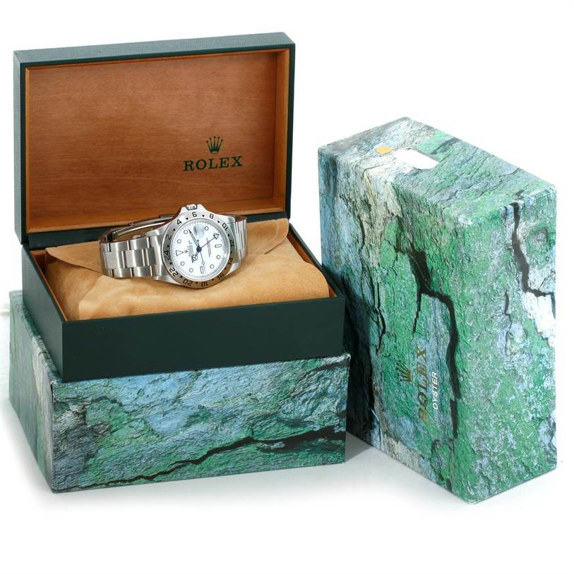 The image shows a Rolex Explorer 16570 Men's Stainless Steel White Dial 16570 Men's Stainless Steel White Dial watch in a padded display box with both the box and an outer packaging displayed.
