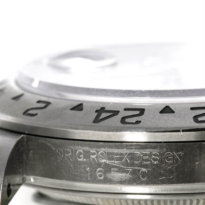 The image shows a close-up side view of the bezel, case, and engraving of a Rolex Explorer 16570 Men's Stainless Steel White Dial 16570 Men's Stainless Steel White Dial watch.