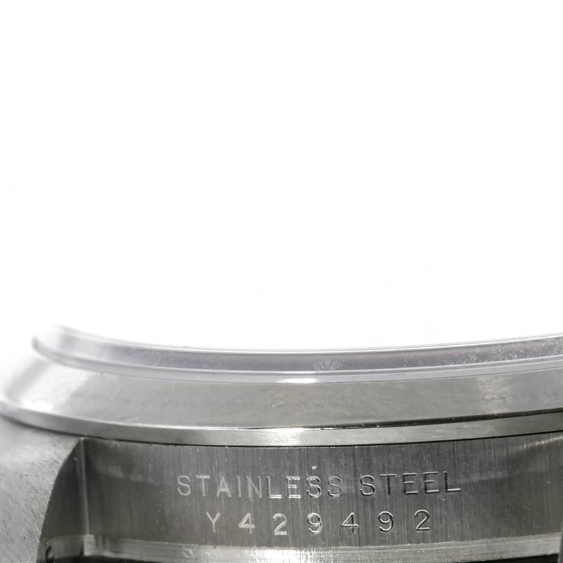 This image shows the side view of a Rolex Explorer 114270 Men's Stainless Steel Black Dial 114270 Men's Stainless Steel Black Dial watch case with the serial number and "STAINLESS STEEL" engraved.