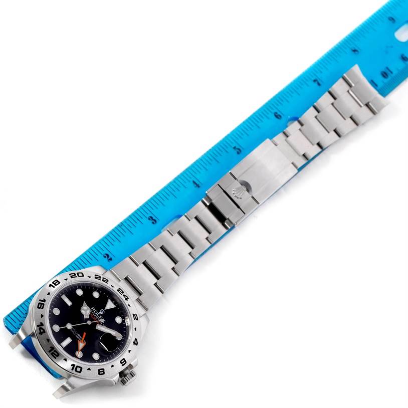 The image shows a Rolex Explorer 216570 Men
s Stainless Steel Black Dial 216570 Men
s Stainless Steel Black Dial watch laid flat with the bracelet extended and a ruler next to it for scale.