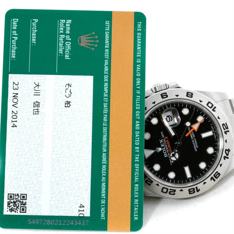 The image shows a partial view of a Rolex Explorer 216570 Men
s Stainless Steel Black Dial 216570 Men
s Stainless Steel Black Dial watch alongside its warranty card from an official Rolex retailer.