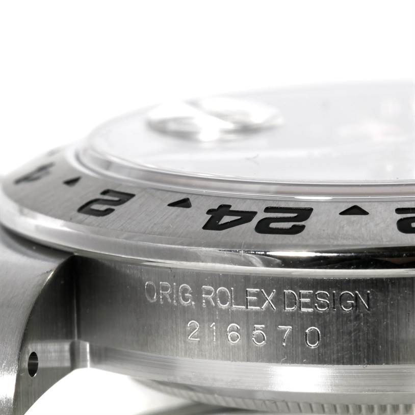 This image shows a close-up side view of a Rolex Explorer 216570 Men
s Stainless Steel Black Dial 216570 Men
s Stainless Steel Black Dial watch bezel and case, displaying the engraved design and reference number "216570."