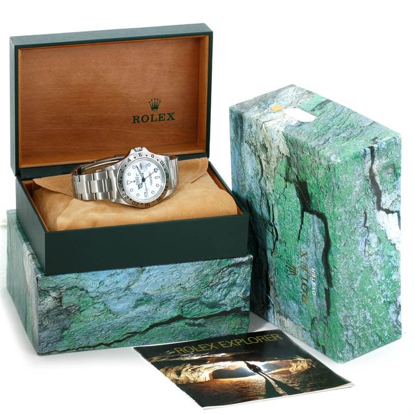 The Rolex Explorer 16570 Men's Stainless Steel White Dial 16570 Men's Stainless Steel White Dial watch is displayed inside its open box, alongside its outer case and a booklet.