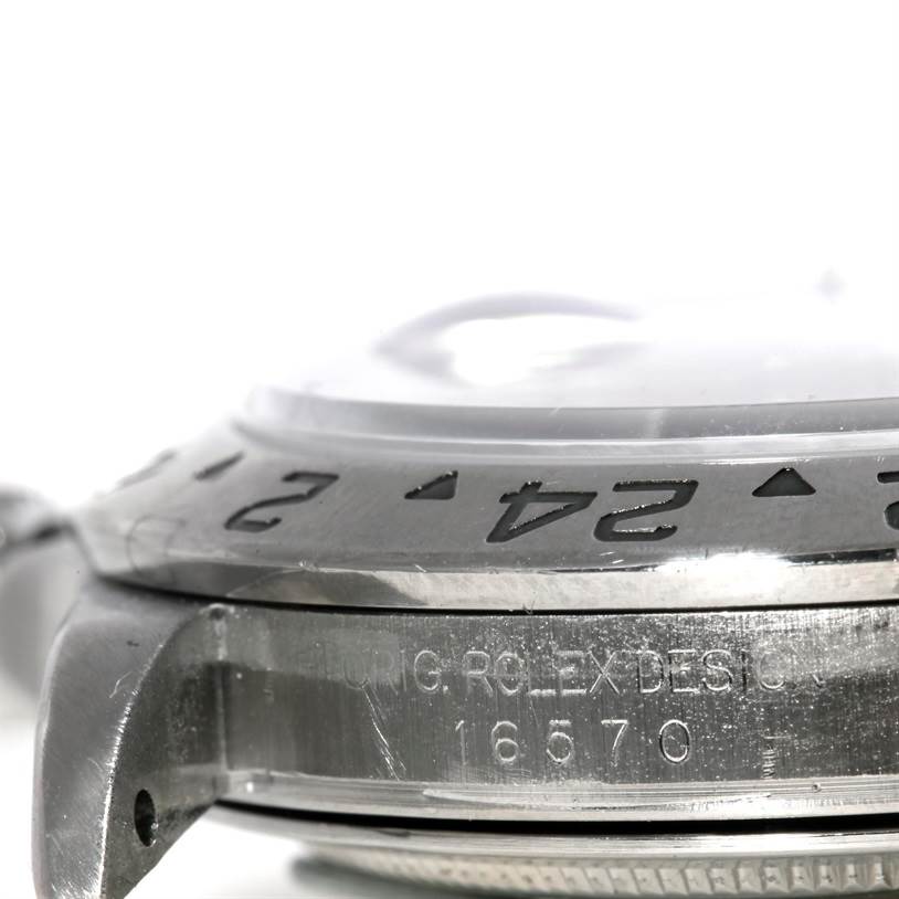 This image shows a close-up side view of the bezel and serial number engraving on a Rolex Explorer 16570 Men's Stainless Steel White Dial 16570 Men's Stainless Steel White Dial.