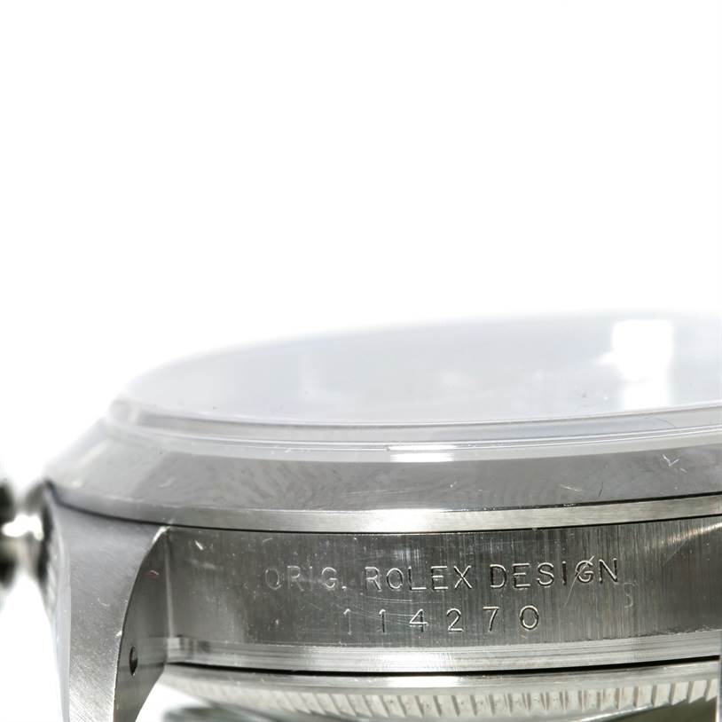 The image shows a close-up of the side of the Rolex Explorer 114270 Men's Stainless Steel Black Dial 114270 Men's Stainless Steel Black Dial watch case, highlighting the engraved model number and brand details.