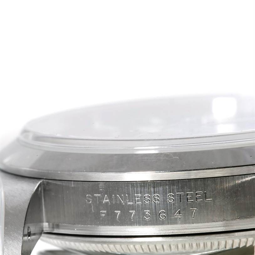 This image shows a close-up side view of a Rolex Explorer 114270 Men's Stainless Steel Black Dial 114270 Men's Stainless Steel Black Dial model, highlighting the case and serial number engraving.