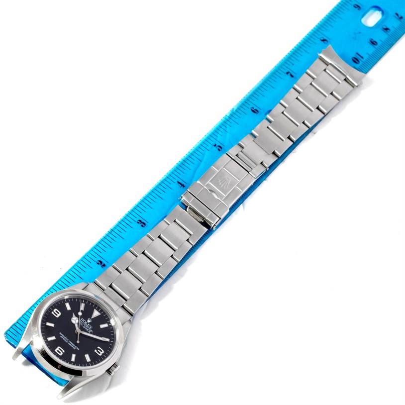 The image shows a Rolex Explorer 14270 Men's Stainless Steel Black Dial 14270 Men's Stainless Steel Black Dial watch laid flat alongside a ruler, displaying its face, bracelet, and clasp.