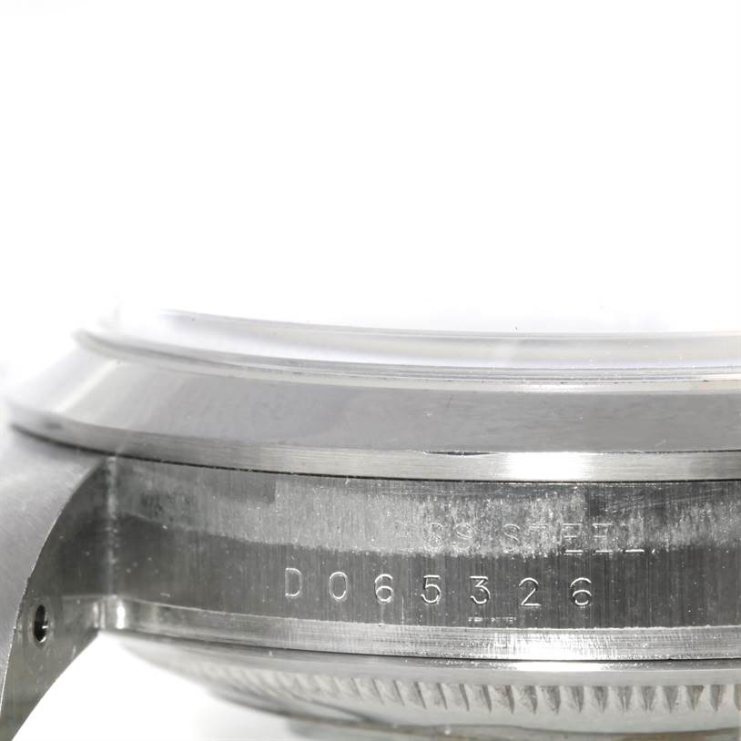 This image shows a close-up view of the case and bezel of a Rolex Explorer 114270 Men's Stainless Steel Black Dial 114270 Men's Stainless Steel Black Dial watch, highlighting the serial number engraving.