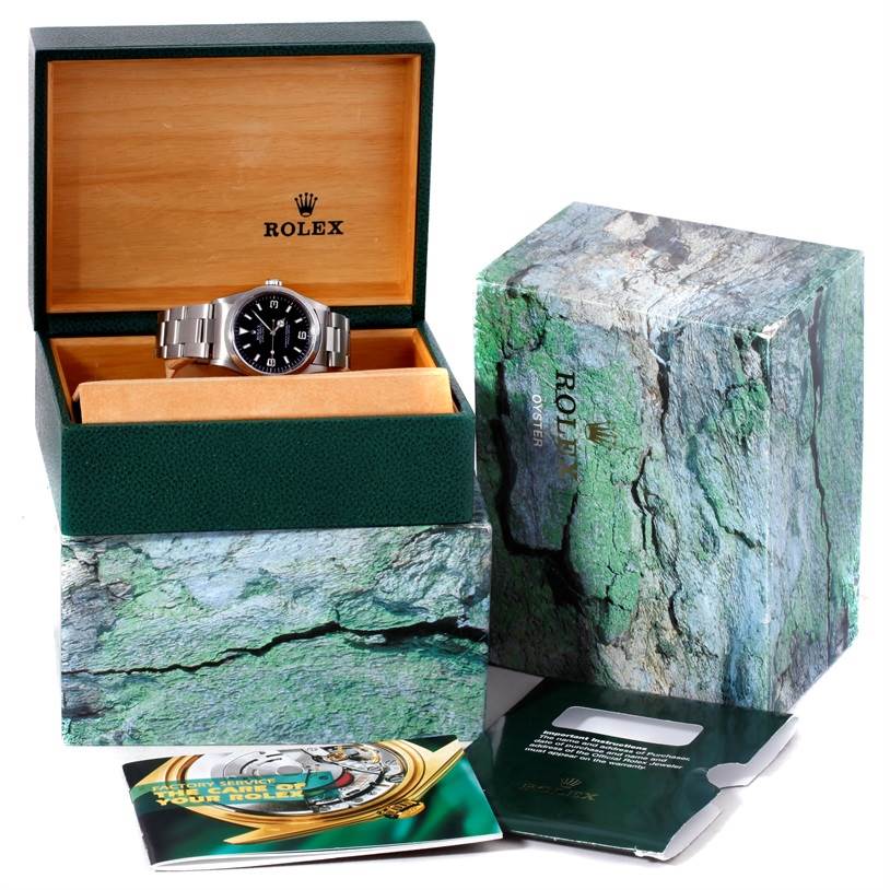 This image shows a Rolex Explorer 14270 Men's Stainless Steel Black Dial 14270 Men's Stainless Steel Black Dial watch in an open green box with outer packaging and accompanying booklets.