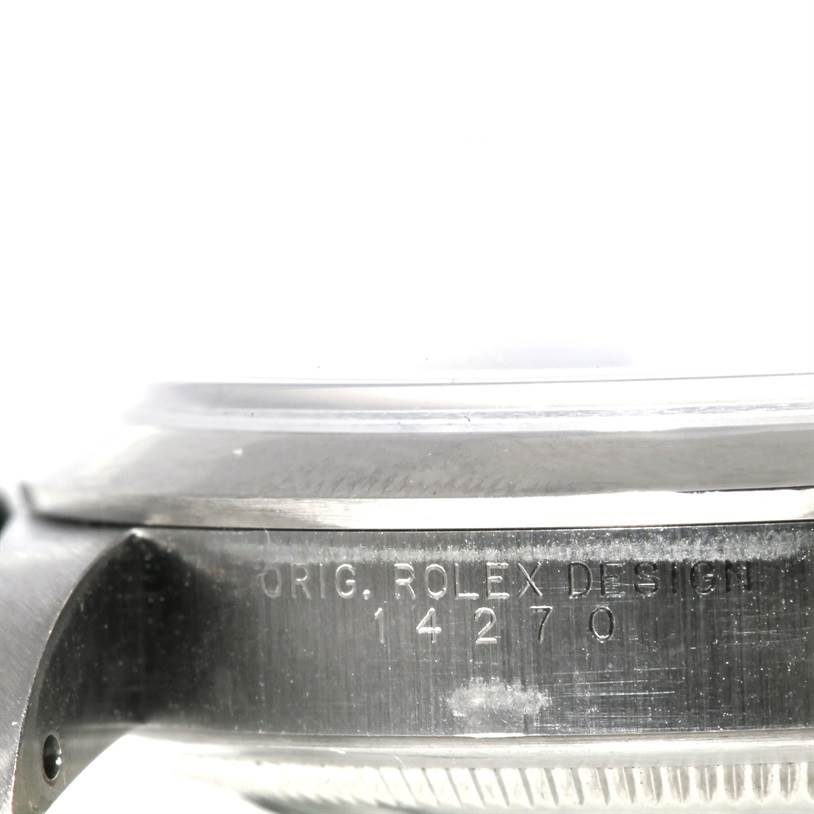 The image shows a close-up side view of the case and bezel of a Rolex Explorer 14270 Men's Stainless Steel Black Dial 14270 Men's Stainless Steel Black Dial, highlighting the engraved serial number.