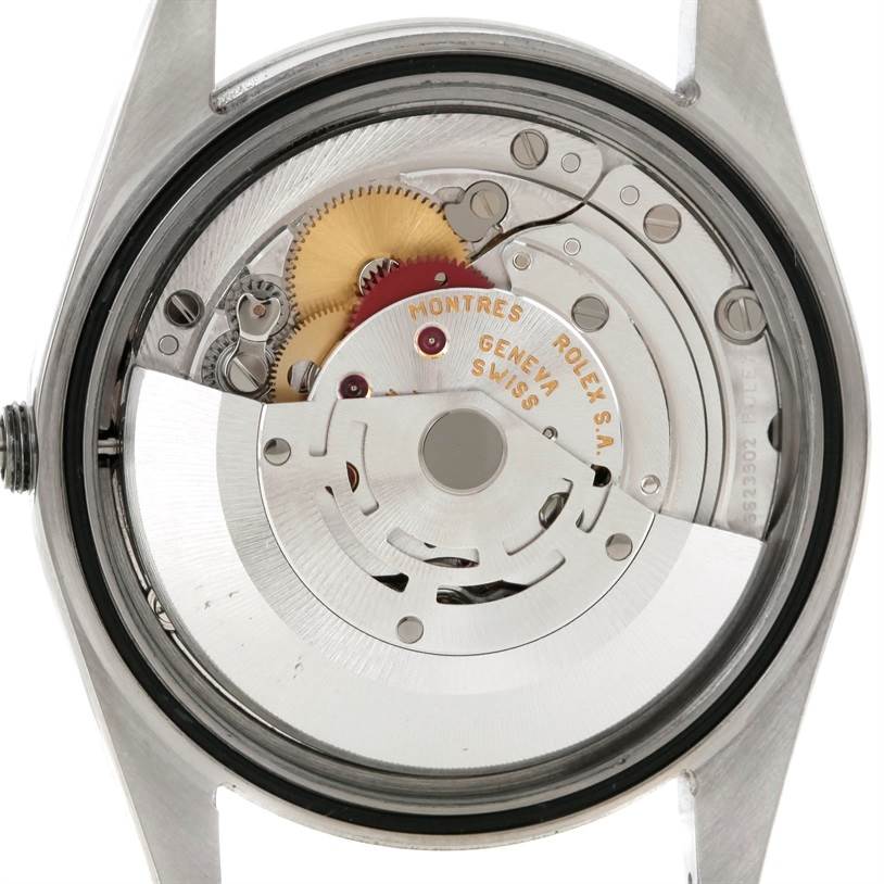 This image shows the internal mechanism of a Rolex Explorer 114270 Men's Stainless Steel Black Dial 114270 Men's Stainless Steel Black Dial watch from the back angle, revealing the intricate gears and movement parts.