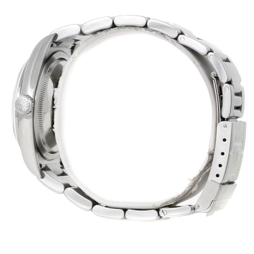 This side view of the Rolex Explorer 114270 Men's Stainless Steel Black Dial 114270 Men's Stainless Steel Black Dial watch shows the case, crown, and metal bracelet with clasp.