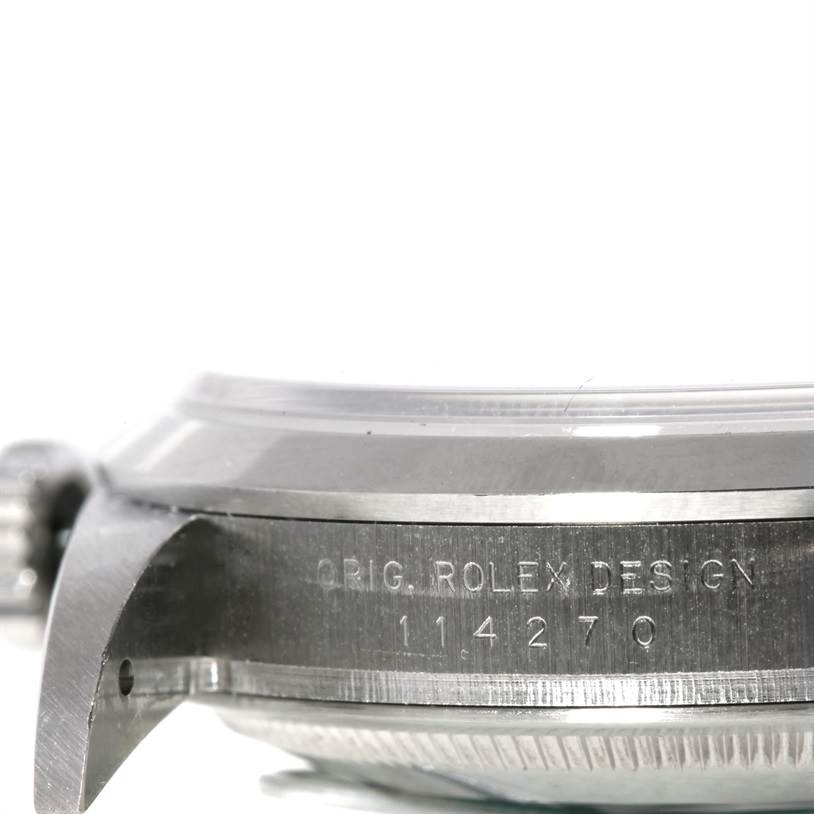 The image shows a close-up side view of the case and bezel of the Rolex Explorer 114270 Men
s Stainless Steel Black Dial 114270 Men
s Stainless Steel Black Dial watch, displaying the model number and engraving.