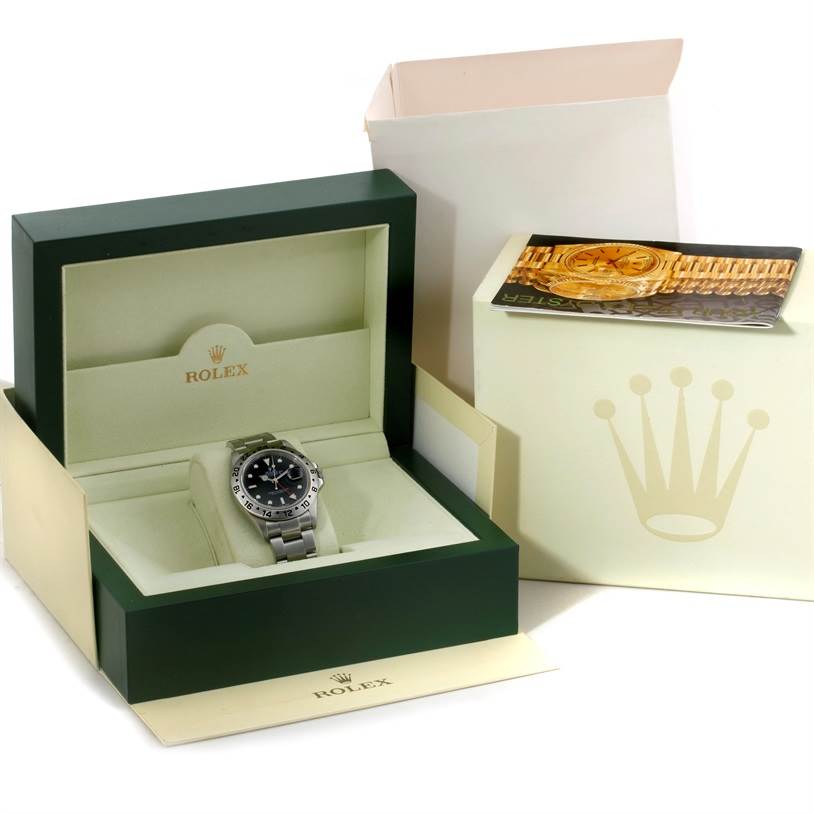 The image shows a Rolex Explorer 16570 Men's Stainless Steel Black Dial 16570 Men's Stainless Steel Black Dial watch inside its green branded box, along with outer packaging and a booklet.