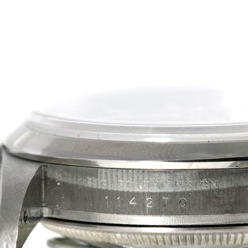 The image shows a close-up side view of the case and bezel of a Rolex Explorer 114270 Men's Stainless Steel Black Dial 114270 Men's Stainless Steel Black Dial watch, highlighting its serial number.