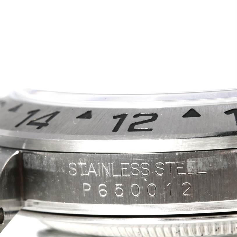 The image shows a close-up side view of the case and part of the bezel of a Rolex Explorer 16570 Men's Stainless Steel Black Dial 16570 Men's Stainless Steel Black Dial watch, displaying "STAINLESS STEEL" and a serial number.