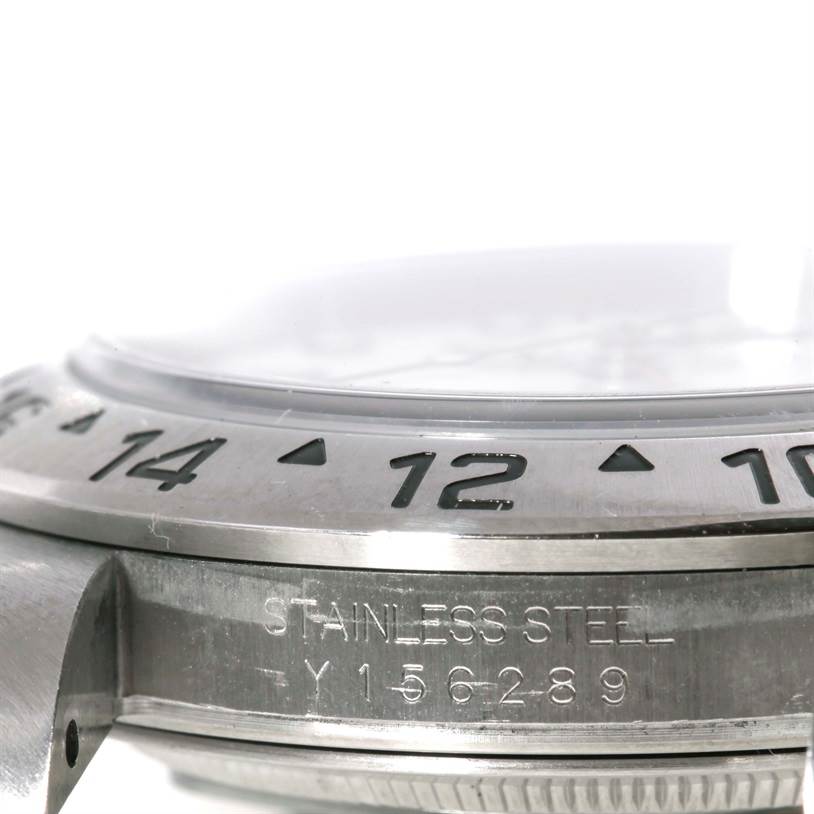 The image shows a close-up angle of the bezel and case of the Rolex Explorer 16570 Men's Stainless Steel White Dial 16570 Men's Stainless Steel White Dial watch, highlighting the "STAINLESS STEEL" engraving and numerals.