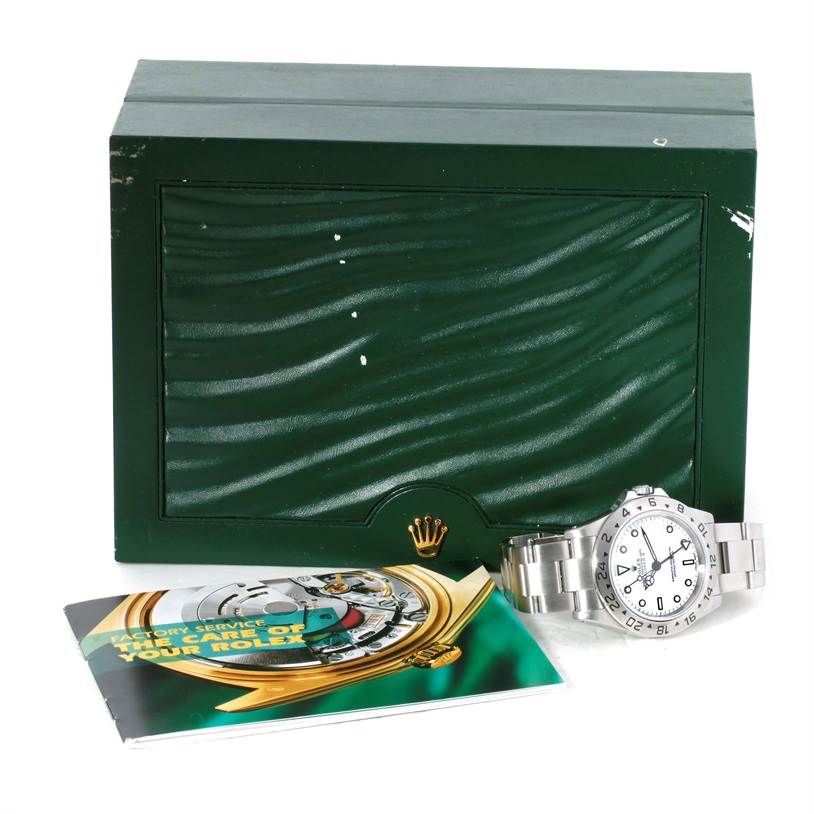 This image shows a Rolex Explorer 16570 Men's Stainless Steel White Dial 16570 Men's Stainless Steel White Dial watch with its box and a booklet, displayed at an angle emphasizing the accessories.