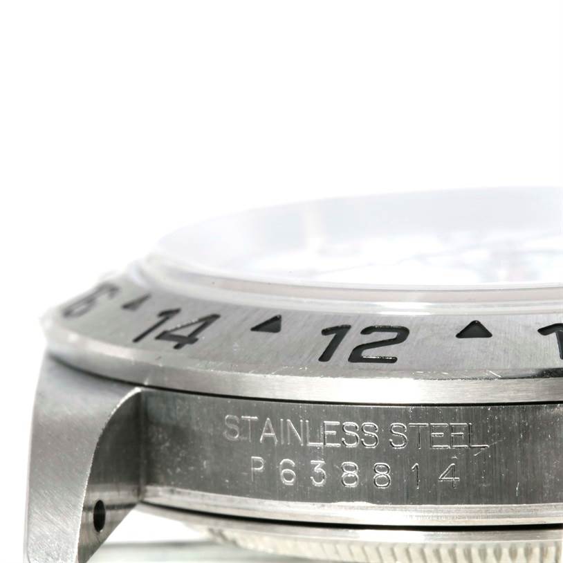 Side view of the bezel and case on a Rolex Explorer 16570 Men's Stainless Steel Black Dial 16570 Men's Stainless Steel Black Dial watch, highlighting the engraved numerals and "STAINLESS STEEL" inscription.