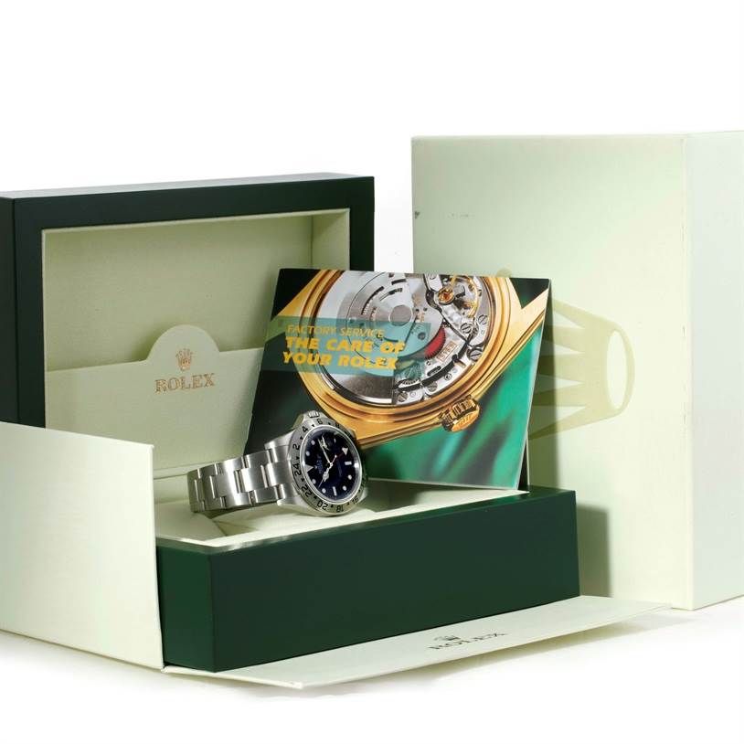 The image shows a Rolex Explorer 16570 Men's Stainless Steel Black Dial 16570 Men's Stainless Steel Black Dial watch inside its open green box, accompanied by a care manual and outer packaging.