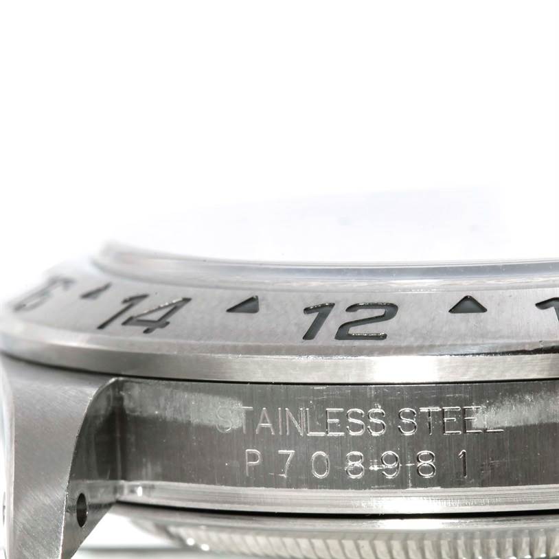 This image shows a close-up side view of the Rolex Explorer 16570 Men's Stainless Steel White Dial 16570 Men's Stainless Steel White Dial's stainless steel case and part of its bezel and serial number.