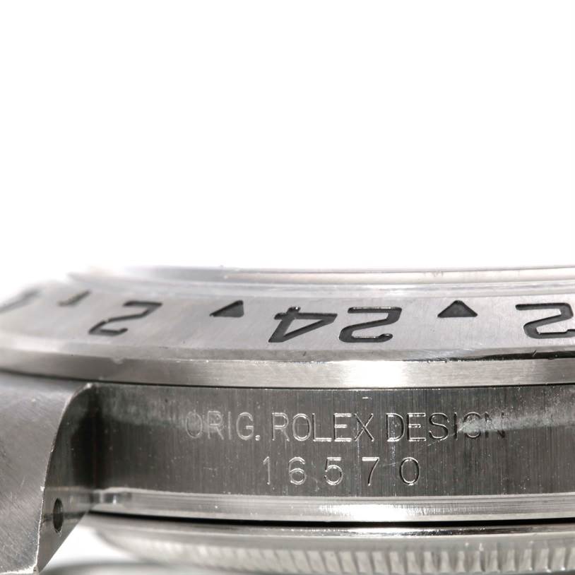 The image shows a side view of a Rolex Explorer 16570 Men's Stainless Steel White Dial 16570 Men's Stainless Steel White Dial watch, displaying the bezel with numbers and part of the engraved case, including the model number 16570.
