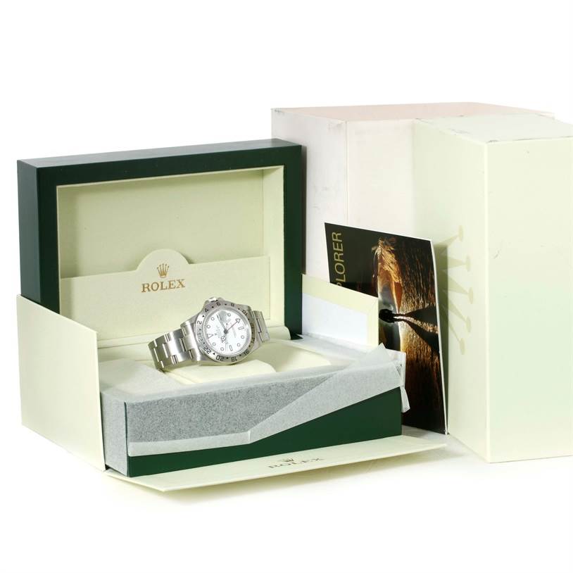 The image shows a Rolex Explorer 16570 Men's Stainless Steel White Dial 16570 Men's Stainless Steel White Dial watch set in an open green box with its accessories.