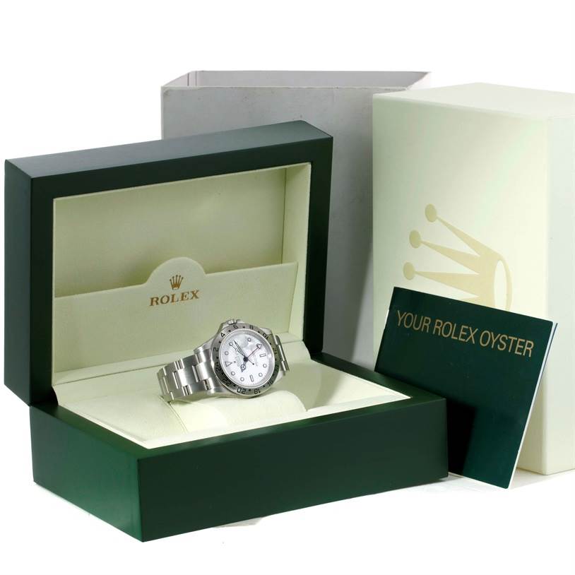 The Rolex Explorer 16570 Men's Stainless Steel White Dial 16570 Men's Stainless Steel White Dial watch is displayed in its box, alongside the outer box and booklet, shown from a slightly angled front view.