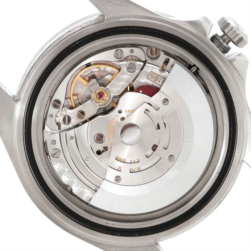 The image shows an internal mechanism of the Rolex Explorer 16570 Men's Stainless Steel White Dial 16570 Men's Stainless Steel White Dial watch with parts including the rotor and balance wheel.