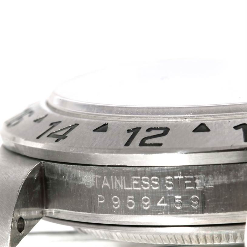 The photo shows a close-up, side view of the bezel and edge of the case of a Rolex Explorer 16570 Men's Stainless Steel White Dial 16570 Men's Stainless Steel White Dial watch, revealing the engraved serial number.