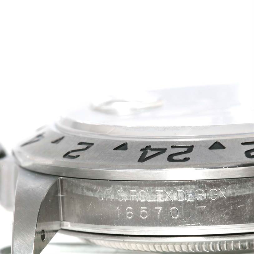 The image shows a close-up angle of the bezel, case, and reference number engraving of a Rolex Explorer 16570 Men's Stainless Steel White Dial 16570 Men's Stainless Steel White Dial watch.
