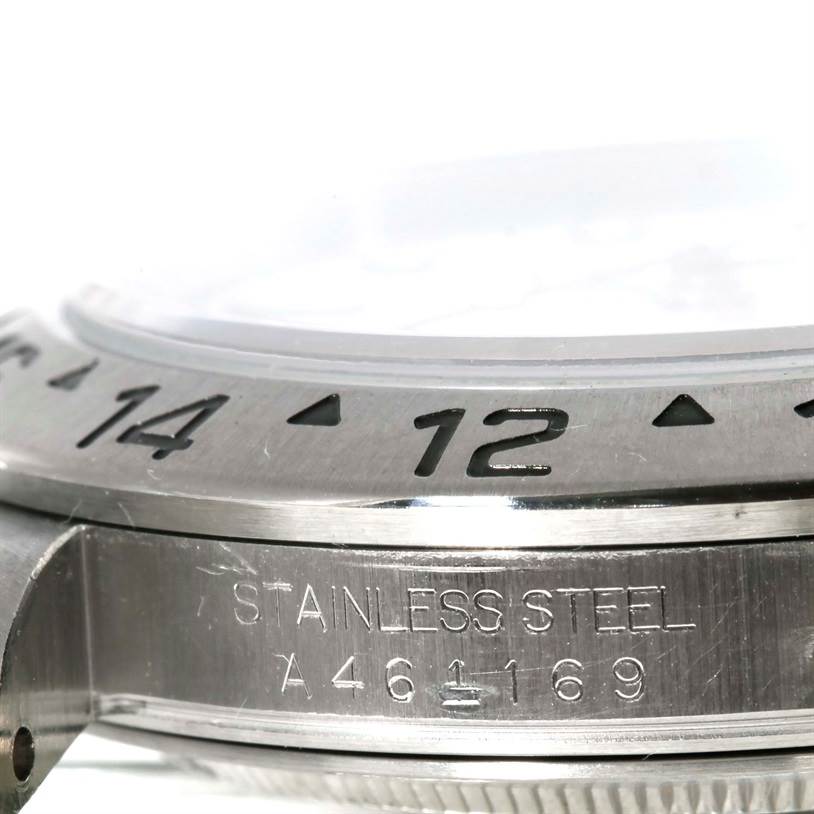 This image shows a close-up of the bezel, case, and engraved details of the Rolex Explorer 16570 Men's Stainless Steel White Dial 16570 Men's Stainless Steel White Dial watch.