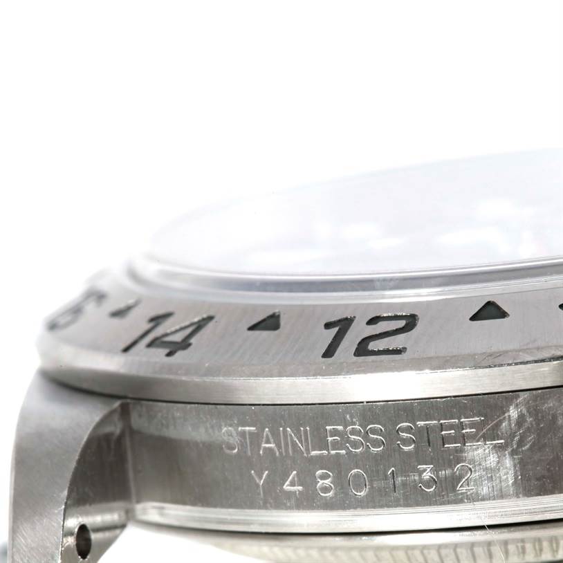 This image shows a close-up side view of the stainless steel bezel and case of a Rolex Explorer 16570 Men's Stainless Steel Black Dial 16570 Men's Stainless Steel Black Dial watch, displaying some engraved numbers and markings.