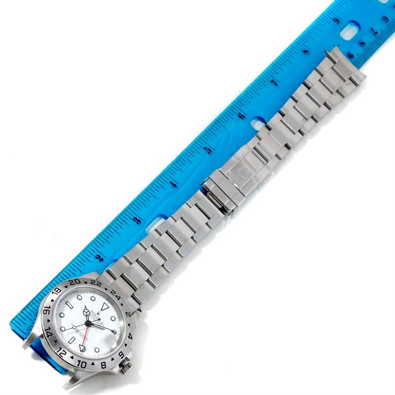 The image shows a Rolex Explorer 16570 Men's Stainless Steel White Dial 16570 Men's Stainless Steel White Dial watch laid flat next to a ruler, displaying the watch face and stainless steel bracelet.