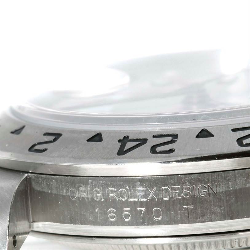 The image shows a close-up of the side and bezel of a Rolex Explorer 16570 Men's Stainless Steel White Dial 16570 Men's Stainless Steel White Dial 16570 watch, highlighting the engraving and numbers.