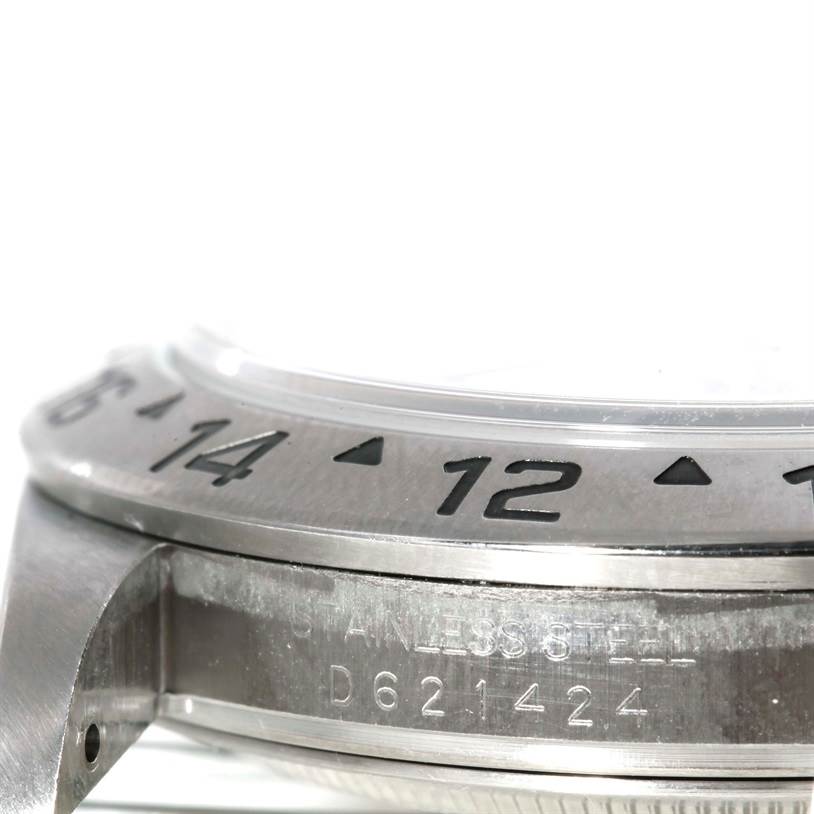 This image shows a close-up angle of the bezel and case side of a Rolex Explorer 16570 Men's Stainless Steel White Dial 16570 Men's Stainless Steel White Dial watch, including part of the serial number.