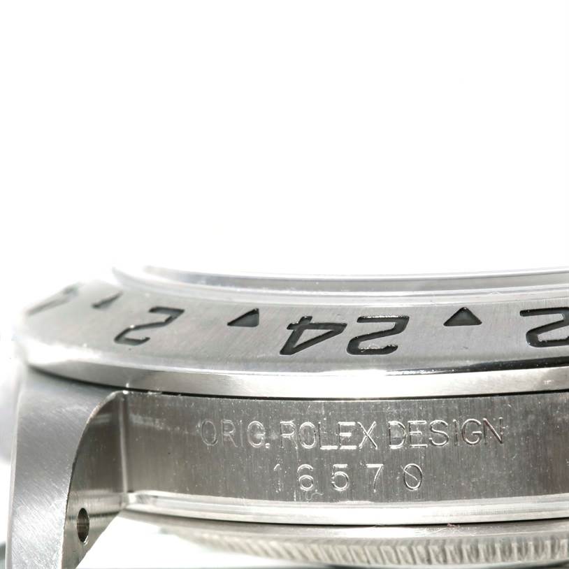 This image shows a close-up side view of the bezel and part of the case of a Rolex Explorer 16570 Men's Stainless Steel Black Dial 16570 Men's Stainless Steel Black Dial watch model 16570.