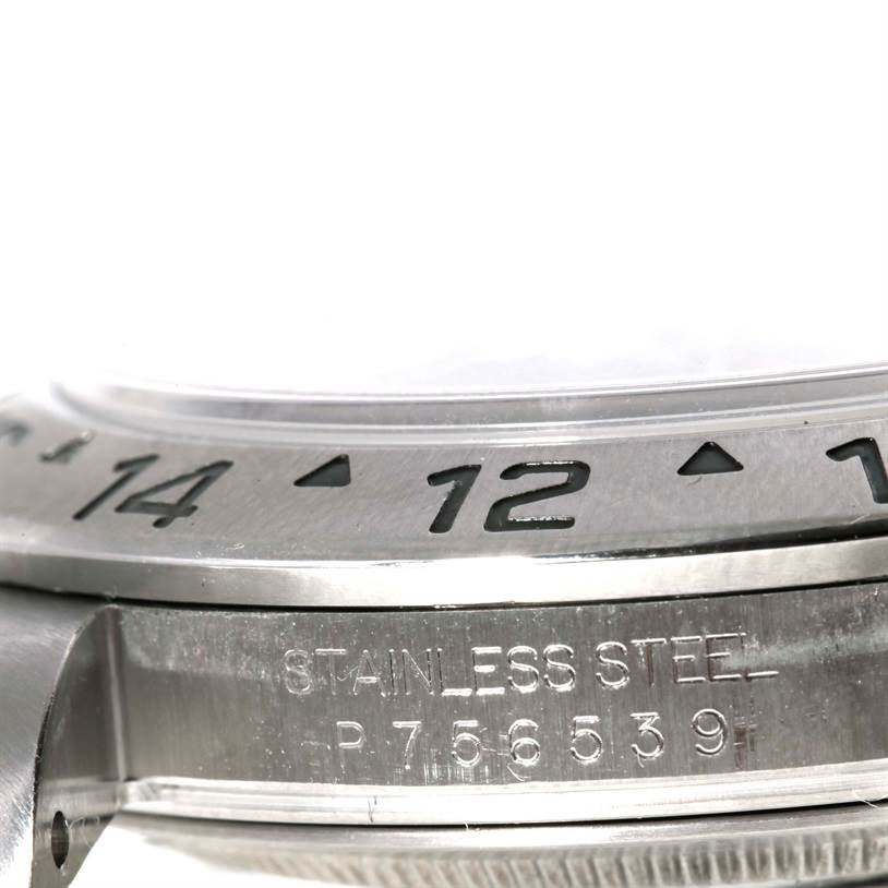 The image shows a close-up side view of the bezel and engraved serial number on a stainless steel Rolex Explorer 16570 Men's Stainless Steel Black Dial 16570 Men's Stainless Steel Black Dial watch.