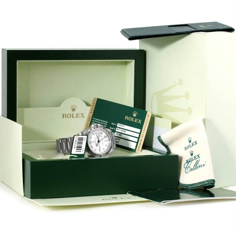 The image shows a Rolex Explorer 16570 Men's Stainless Steel White Dial 16570 Men's Stainless Steel White Dial watch with its accessories, including the box, warranty card, and booklet, at an angle facing forward.
