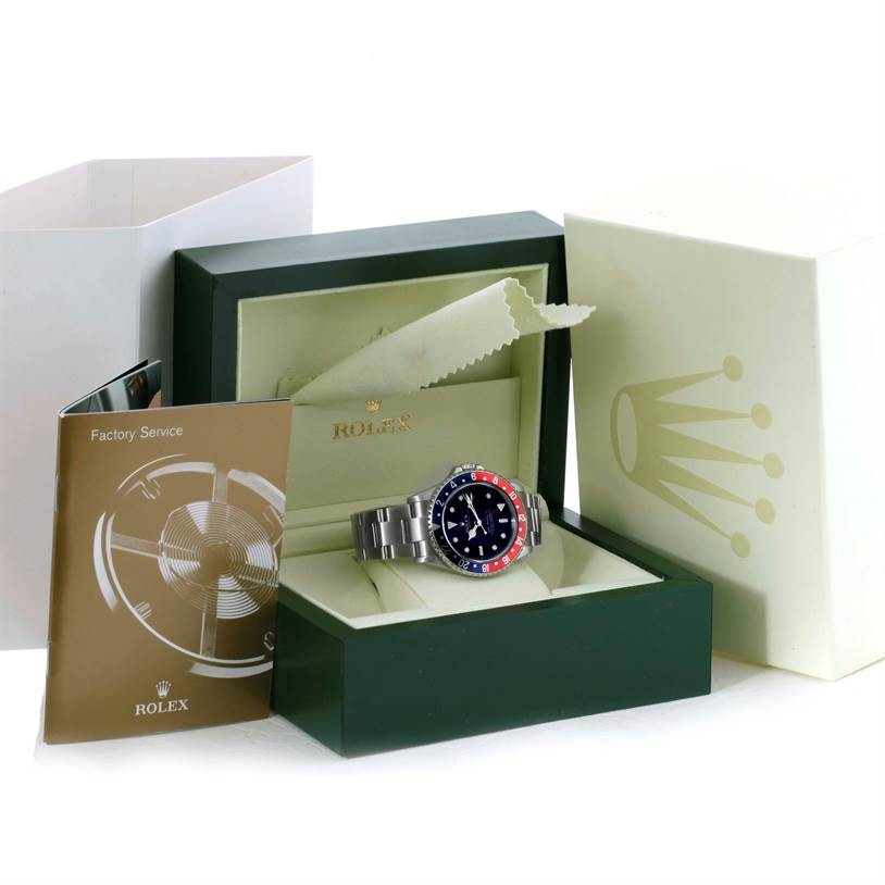 The Rolex GMT-Master 16710 Men
s Stainless Steel Black Dial 16710 Men
s Stainless Steel Black Dial watch is displayed in its open box, with accompanying manuals and packaging in view.