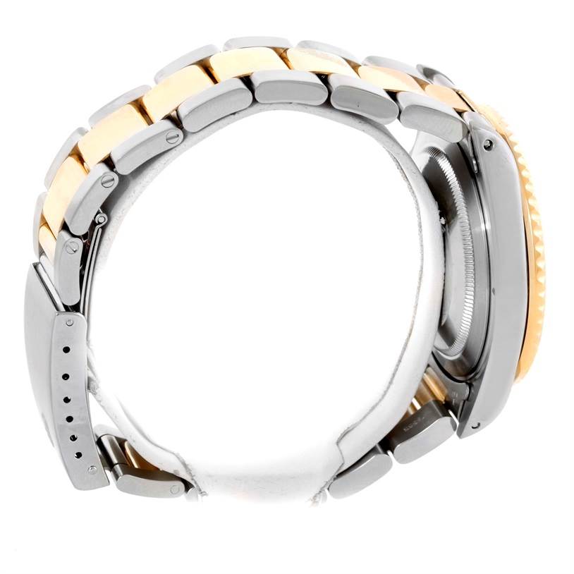 The image shows a side profile of a Rolex GMT-Master 16713 Men's Stainless Steel Black Dial 16713 Men's Stainless Steel Black Dial watch, highlighting the stainless steel and gold bracelet and case.